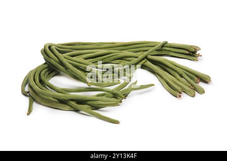 A bunch of fresh long green beans, also known as yardlong beans, arranged on a white background, highlighting their length and texture. Stock Photo