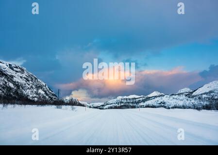 Ice Road leading to a valley in the Arctic at sunset Stock Photo