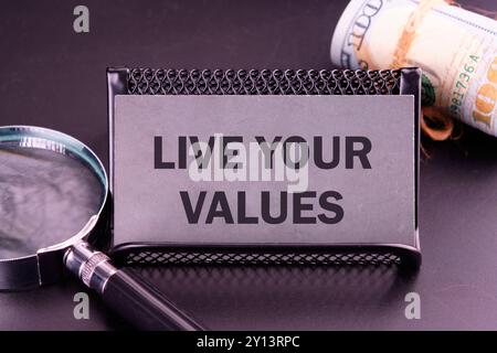 Business, psychological and live your values concept. Copy space. LIVE YOUR VALUES words written on the card in dark colors Stock Photo