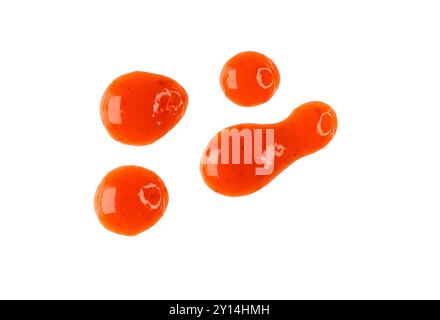 Drops of red hot chilli sauce isolated on white, top view, clipping path Stock Photo