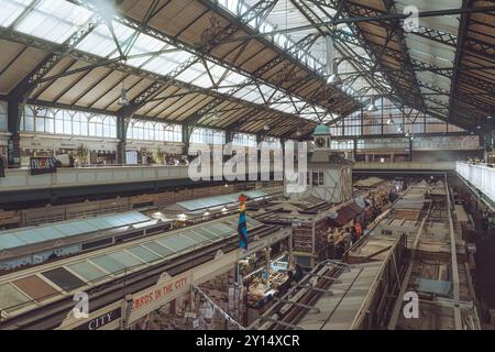 Atmospheric indoor photo of Cardiff Market, taken around lunchtime when the food stalls start serving. Stock Photo