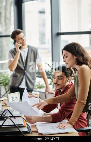 Team members review documents during working process. Stock Photo