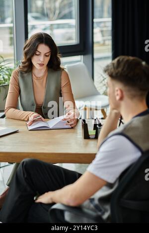 Two professionals engage in a serious discussion about layoffs. Stock Photo