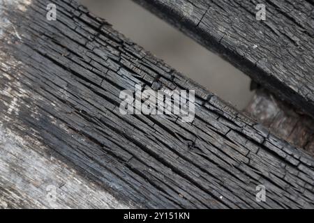 Charred slats of wood on picnic table Stock Photo