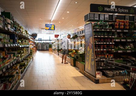 A shopper customer person shopping inside a Lidl shop store in England in the UK. Stock Photo