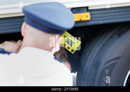 Burghausen, Germany. 05th Sep, 2024. A police officer from the Bavarian border police uses a so-called person detection device to check whether there are people hidden in the semi-trailer of a truck during a press event at a checkpoint. The person detection device can detect even minimal vibrations in a vehicle. At the press event, information will be provided on the current situation at the Bavarian borders with Austria and the Czech Republic as well as on measures to strengthen border protection. Credit: Matthias Balk/dpa/Alamy Live News Stock Photo