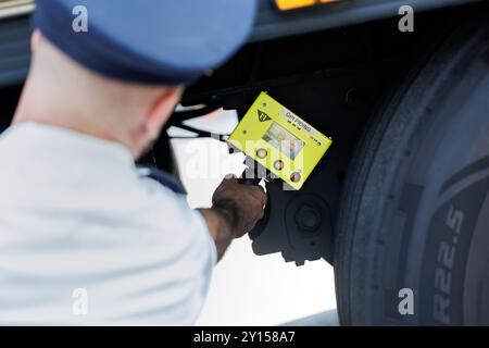 Burghausen, Germany. 05th Sep, 2024. A police officer from the Bavarian border police uses a so-called person detection device to check whether there are people hidden in the semi-trailer of a truck during a press event at a checkpoint. The person detection device can detect even minimal vibrations in a vehicle. At the press event, information will be provided on the current situation at the Bavarian borders with Austria and the Czech Republic as well as on measures to strengthen border protection. Credit: Matthias Balk/dpa/Alamy Live News Stock Photo