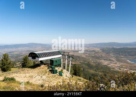 A green ski lift from atop Bald Mountain overlooking a valley at Deer Valley. Stock Photo