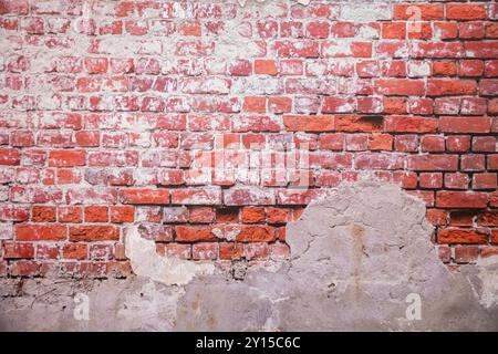 A white brick and orange brick wall. A orange painted old brick wall background. Stock Photo