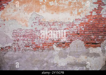 A white brick and orange brick wall. A orange painted old brick wall background. Stock Photo