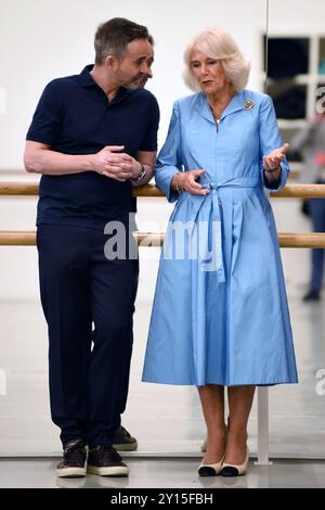 Aaron S. Watkin, Artistic Director and Queen Camilla, Patron of English National Ballet watch rehearsals at the English National Ballet's Mulryan Centre for Dance in east London. This is the Queen's first official visit to the English National Ballet since being made its patron earlier this year. Picture date: Thursday September 5, 2024. Stock Photo