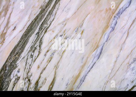 High-resolution marble texture featuring golden and gray veins on a smooth surface. Stock Photo