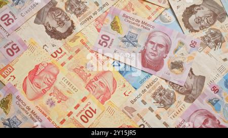 Mexican pesos banknotes scattered, highlighting colorful currency from banco de mexico in various denominations. Stock Photo