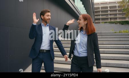 Caucasian business entrepreneurs walk success achievement gesture good idea agreement two people walking in city discuss colleagues coworkers man Stock Photo