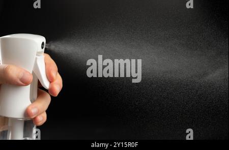 Elegant water jet spray coming out from plastic bottle nozzle close up view Stock Photo