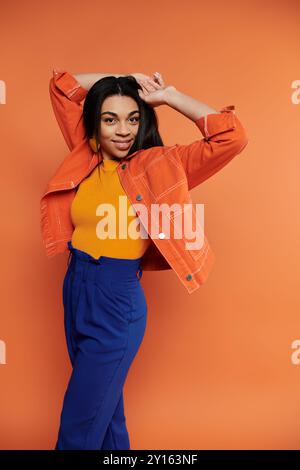 A cheerful woman showcases her vibrant outfit with confidence and flair. Stock Photo