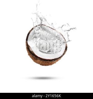 Fresh coconut water splashing from nut in air on white background Stock Photo