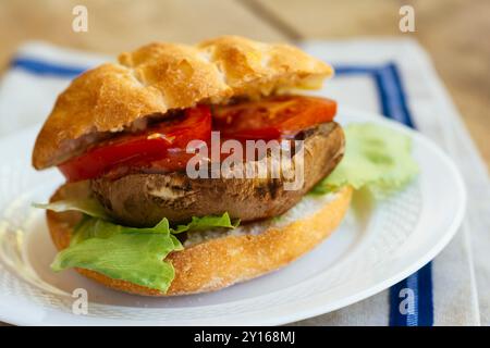 Grilled portobello mushroom burger with tomato and lettuce Stock Photo