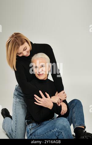 A woman and her daughter share a warm embrace and joyful laughter. Stock Photo