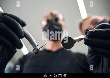 Dentist works in special binocular dental glasses Stock Photo