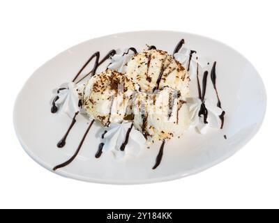 Decadent Vanilla Ice Cream Scoops with Chocolate Drizzle on White Plate. Stock Photo