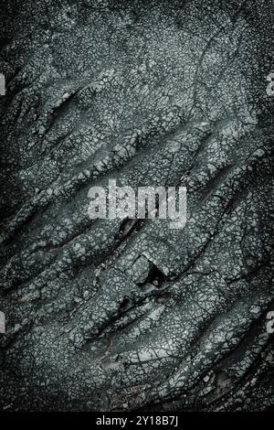 Dark grey cracked lava stone texture background Stock Photo