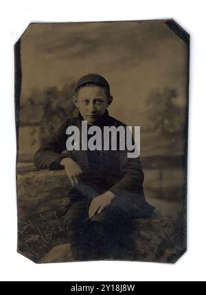 Antique Tintype Portrait of Young Victorian Era Boy Wearing a Cap Stock Photo