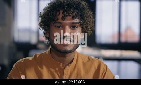 Portrait of happy Indian Arabian ethnic muslim guy creative designer smart young businessman leader male cheerful smile toothy looking at camera in Stock Photo