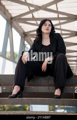 Modern Businesswoman in Urban Setting Exudes Confidence. Stock Photo