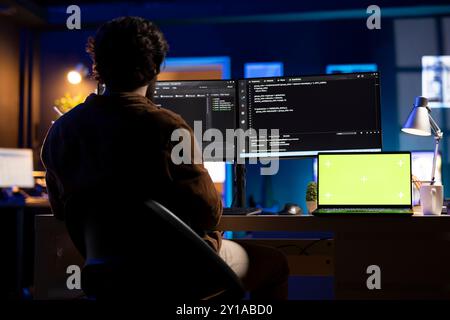 Programmer designing and developing software applications using isolated screen laptop. IT professional implementing and maintaining company systems using mockup notebook Stock Photo
