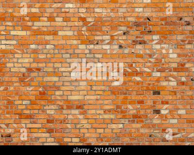 The texture of a brick wall with irregular shapes of bricks and different shades of red. Background images for text or graphics. Stock Photo