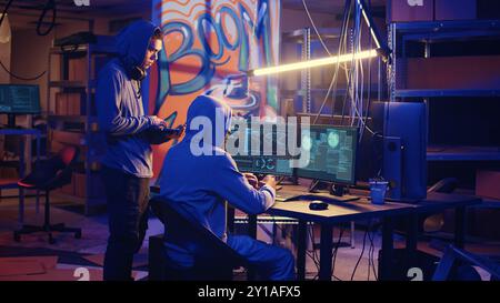 Spies in secret hideout trying to steal valuable data by hacking governmental websites but getting their attacks rejected by strong security, seeing access denied error message on screen Stock Photo