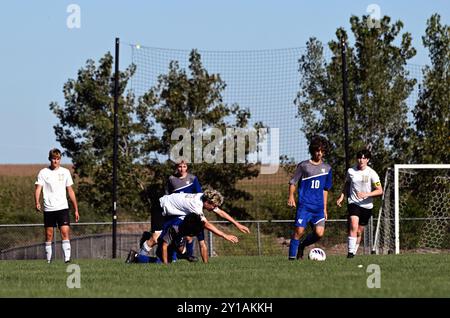 Illinois, USA. Midfielder being upended while in pursuit of the ball. Stock Photo