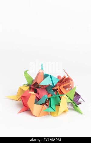 Creative, studio and stack with origami bird for handmade, geometric design and art decoration. Japanese, craft and paper bunch with animal on white Stock Photo