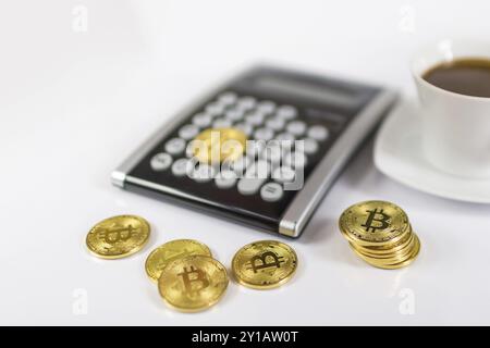 Bitcoin coin with calculator as a tax payment concept Stock Photo