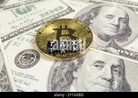 Cryptocurrency Bitcoin on a Dollar bills. Tax paying concept Stock Photo