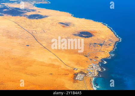 Montana Cavera old volcano behind Caleta de Famara in northwest of Lanzarote. Aerial view showcasing the stunning landscape of Lanzarote, island in Ca Stock Photo