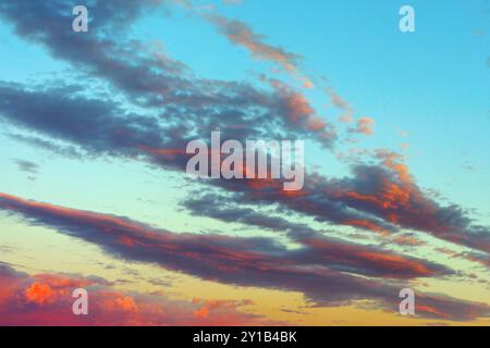 Mix of blue and orange clouds on the morning sky. Sky is filled with clouds and the sun is rising Stock Photo