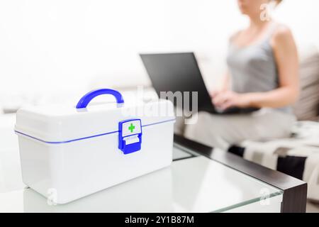 First aid kit. Woman choosing pills in online pharmacy Stock Photo