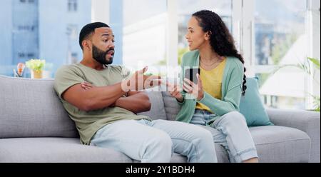 Phone, affair and couple with argument on sofa in living room for divorce, cheating or breakup. Cellphone, upset and young man and woman fighting for Stock Photo