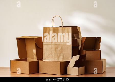 Brown Paper Bag and Cardboard Boxes on a Wooden Surface Stock Photo