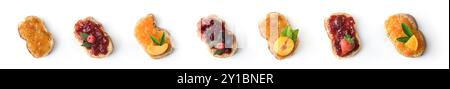 Set of bread toasts with various fruit jam decorated with pieces of fruit isolated on white background. Top view. Stock Photo