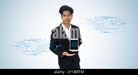 Professional businessman in suit holding tablet computer with shield symbol display on screen. Concept and idea for technology, innovation and securit Stock Photo