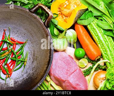 Preparation to asian traditional cooking. Wok and vegetables. Stock Photo