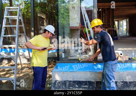 Installing European style windows in a house construction site, Toronto, Canada Stock Photo