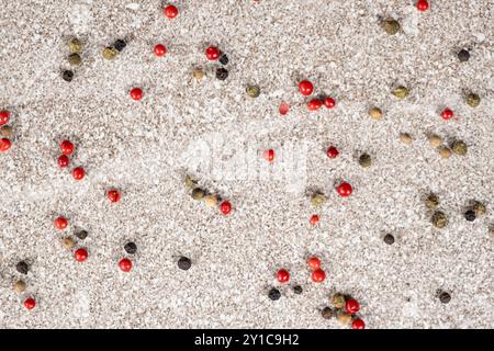 Multicolored peppercorns on a stone gray background. Stock Photo