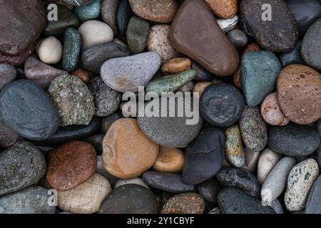 Wet pebbles on the sea shore Stock Photo