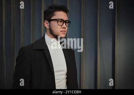 Young man confidently poses at dusk Stock Photo