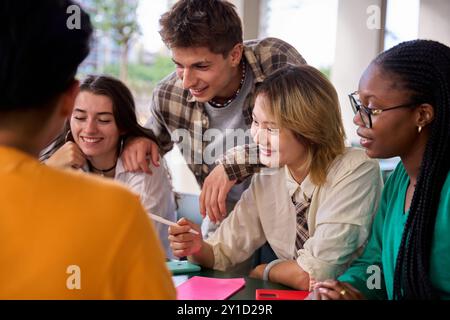 Group of international young university students meeting together looking homework in campus study. Stock Photo