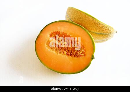 Cantaloupe melon cut in half isolated on a white background. Healthy and vegetarian food. Directly above. Copy space. Stock Photo